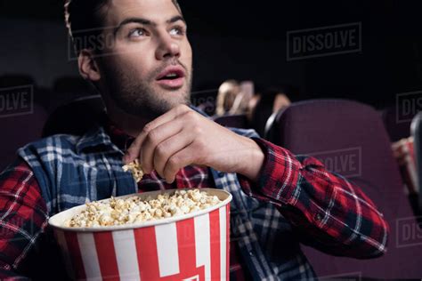Why do people eat popcorn in theaters?