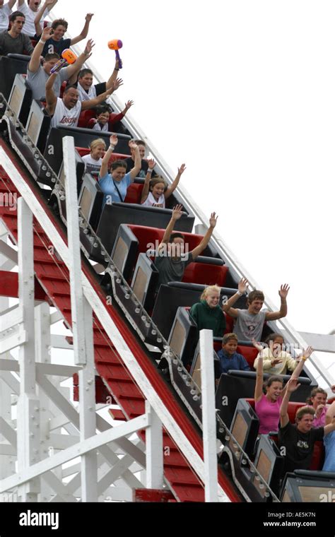 Why do people raise their hands on roller coasters?