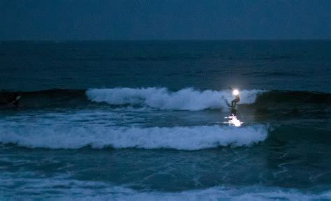 Why do surfers surf at night?