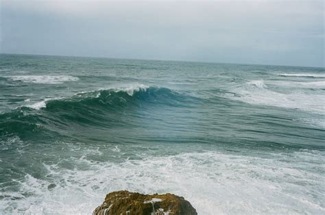 Why do waves break on the beach?