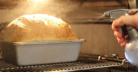 Why do you spray water in the oven when baking bread?