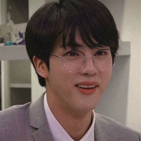 Why does Jin wear fake glasses?