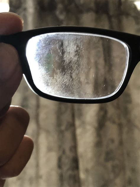Why is the protective coating on my glasses coming off?