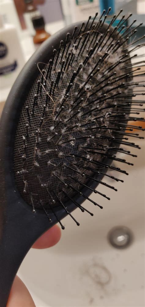 Why is there gray fuzz in my hairbrush?