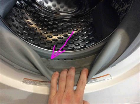 Why is water staying in my washing machine door seal?