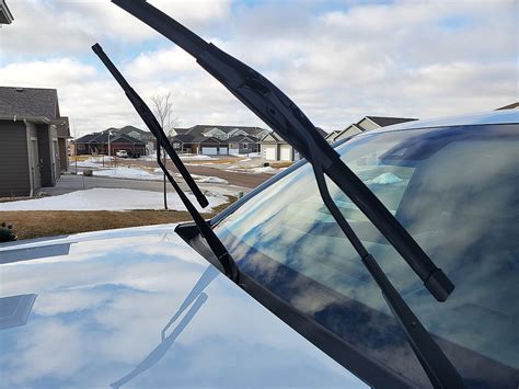 Why should you never leave your windshield wipers raised in winter?