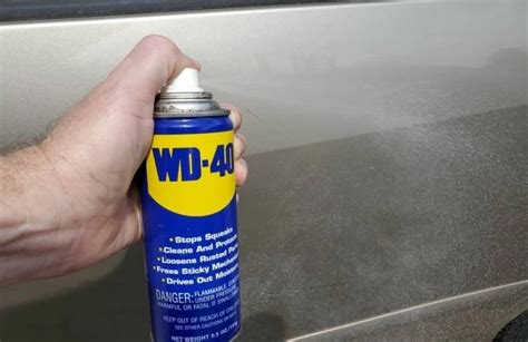 Will WD-40 remove adhesive from car paint?